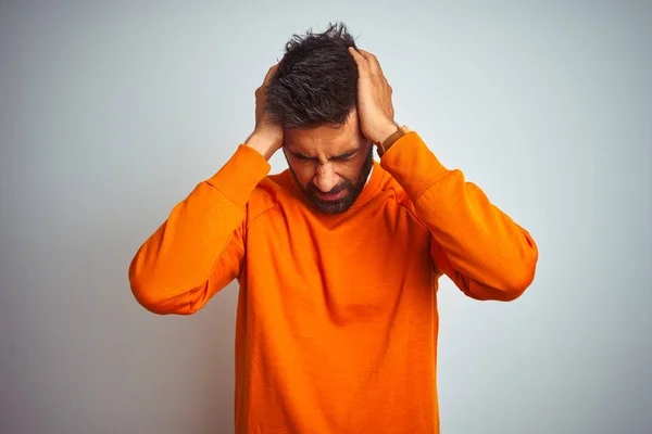 Ung Indisk Man Klädd Orange Tröja Över Isolerad Vit Bakgrund — Stockfoto