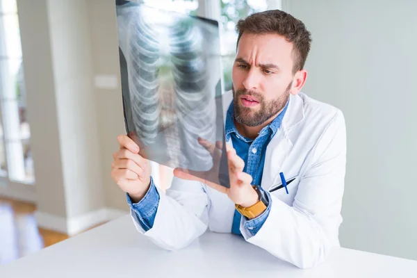 Doctor man looking at x-ray radiography doing body examination
