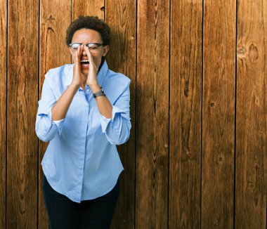 Eller genç güzel Afro-Amerikan iş kadın ile kızgın yüksek sesle bağırarak izole arka plan üzerinde ağzına