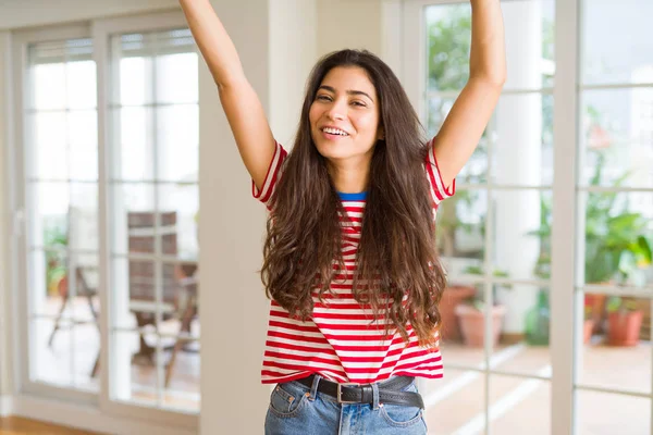 Beautiful young woman celebrating excited for success, screaming
