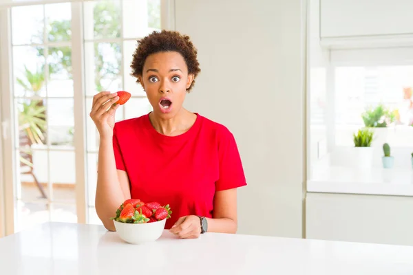 Young African American Woman Eating Fresh Strawberries Breakfast Scared Shock — Stock Photo, Image