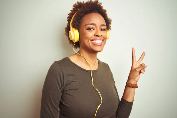 African American Woman Wearing Headphones Listening Music Isolated Background Smiling — Stock Photo, Image