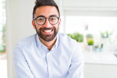 Gözlük takan ve neşeli gülümseyen yakışıklı iş adamı 