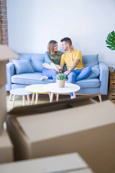 Young beautiful couple sitting and hugging on the sofa at new ap — Stock Photo, Image
