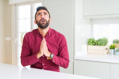 Yalvarıyor ve umut ifade yüzünde çok duygusal ve endişe ile birlikte elleriyle dua yakışıklı İspanyol iş adamı. Bağışlanmak. Din kavramı.