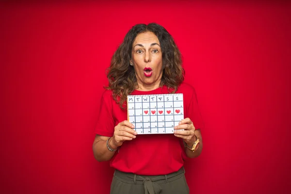 Middle Age Senior Woman Holding Menstruation Calendar Red Isolated Background — Stock Photo, Image