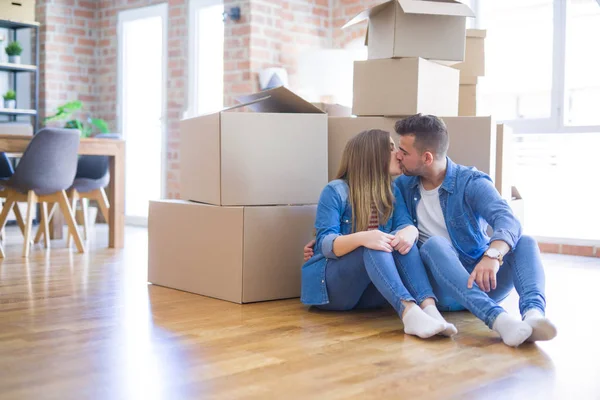 Young beautiful couple in love moving to new home, sitting on th — Stock Photo, Image