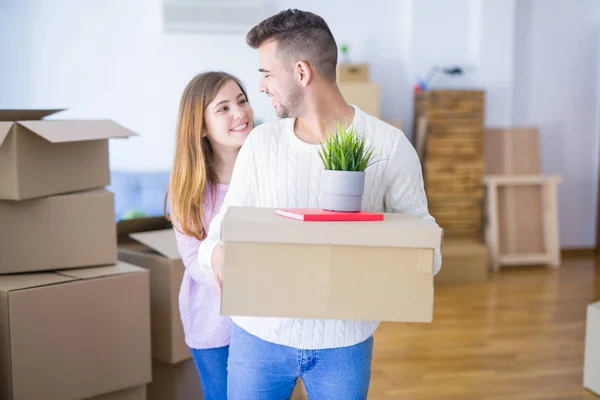 Jong mooi paar in liefde verhuizen naar nieuw huis, holding cardb — Stockfoto