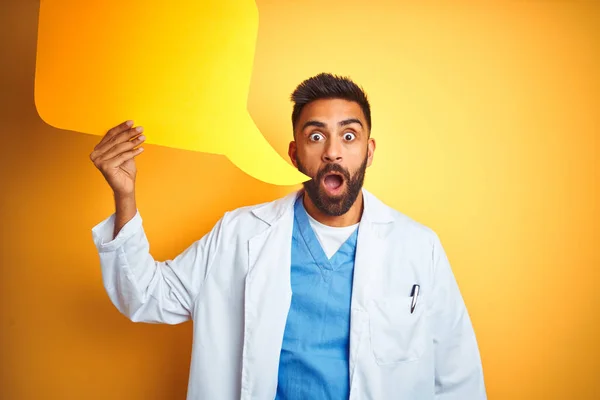 Young Indian Doctor Man Holding Speech Bubble Standing Isolated Yellow — Stock Photo, Image