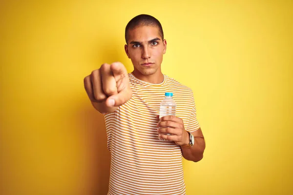 Young Handsome Man Holding Plastic Water Bottle Yellow Isolated Background — Stock Photo, Image