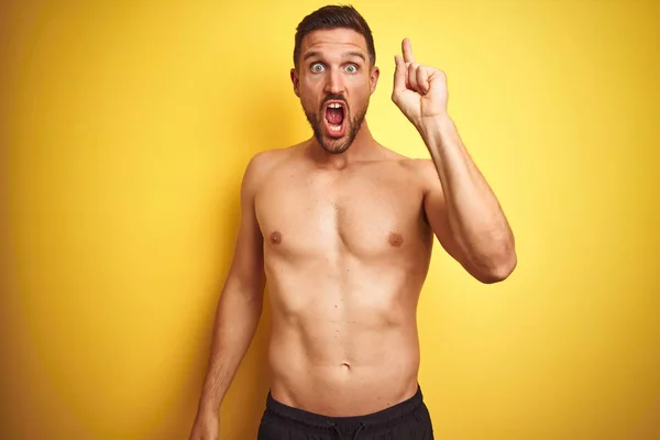 Young Handsome Shirtless Man Isolated Yellow Background Pointing Finger Successful — Stock Photo, Image