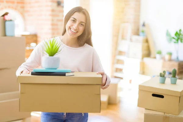 Mooie jonge vrouw glimlachend gelukkig verhuizen naar een nieuw huis, zeer e — Stockfoto