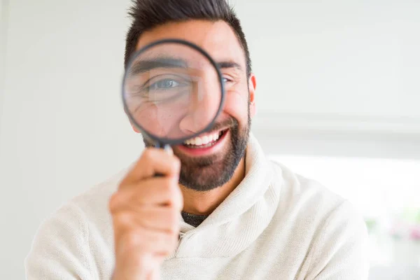 Bonito homem usando lupa, fazendo caras engraçadas — Fotografia de Stock