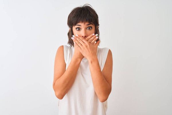Young beautiful woman wearing casual t-shirt standing over isolated white background shocked covering mouth with hands for mistake. Secret concept.