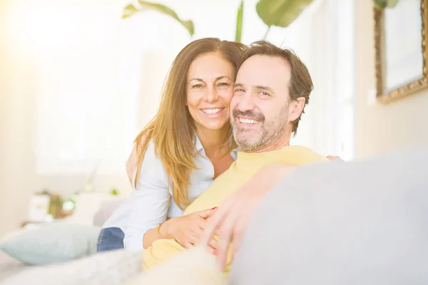 Middle age romantic couple sitting on the sofa at home — Stock Photo, Image