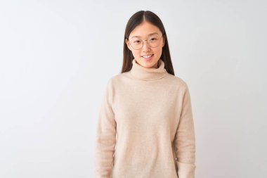 Genç Çinli kadın boğazlı kazak ve gözlük üzerinde izole beyaz arka plan üzerinde mutlu ve serin bir gülümseme ile giyiyor. Şanslı kişi.