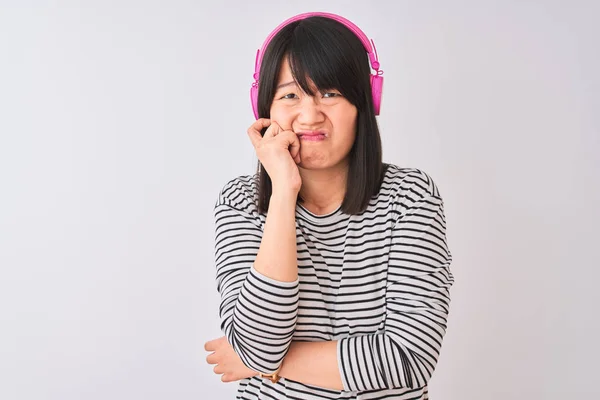 Chinese Woman Listening Music Using Pink Headphones Isolated White Background Royalty Free Stock Images