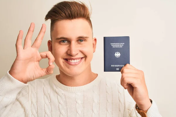 Młody Przystojny Mężczyzna Trzyma Niemcy Niemiecki Paszport Białym Tle Biały — Zdjęcie stockowe