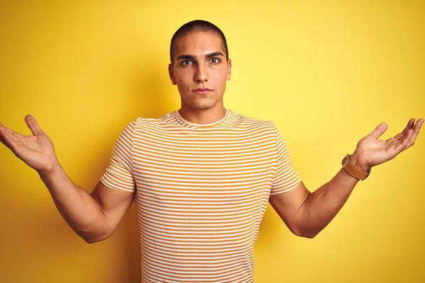 Young Handsome Man Wearing Striped Shirt Yellow Isolated Background Clueless — Stock Photo, Image