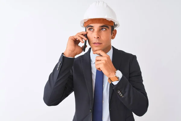 Young Architect Man Wearing Helmet Talking Smartphone Isolated White Background — Stock Photo, Image