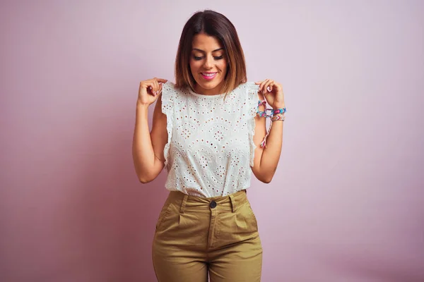 Young beautiful hispanic woman standing wearing green t-shirt