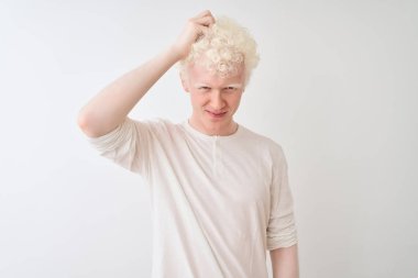 Genç albino sarışın adam izole beyaz arka plan üzerinde duran rahat t-shirt giyen kafa karıştırıcı ve soru hakkında merak ediyorum. Şüpheyle belirsiz, eliyle kafada düşünmek. Pensive kavramı.