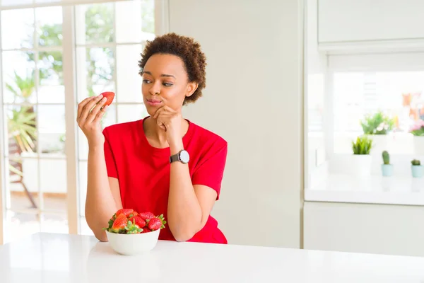 Young African American Woman Eating Fresh Strawberries Breakfast Serious Face — Stock Photo, Image