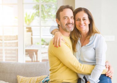 Evde kanepede oturan orta yaş romantik çift