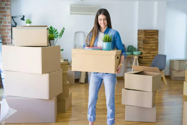 Hermosa mujer joven sosteniendo caja de cartón en el nuevo apartamento, sm —  Fotos de Stock