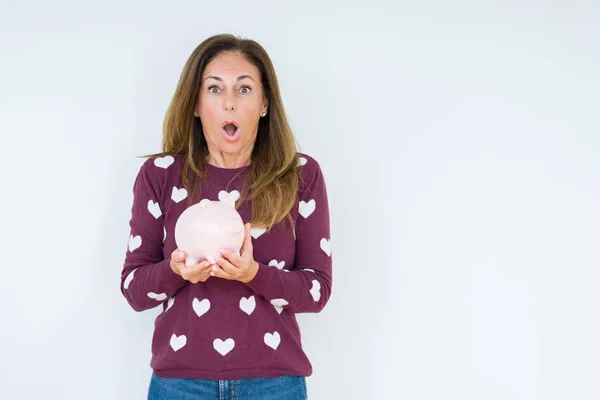 Middle Age Woman Holding Piggy Bank Isolated Background Scared Shock — Stock Photo, Image