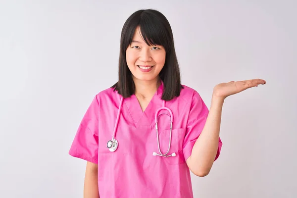 Młoda Piękna Chińska Pielęgniarka Ubrana Stetoskop Białym Tle Uśmiechnięta Prezentując — Zdjęcie stockowe