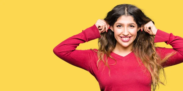 Young Beautiful Woman Wearing Red Sweater Smiling Pulling Ears Fingers — Stock Photo, Image