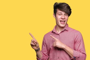 Genç yakışıklı iş adamı gülümseyen ve iki elleri ve parmakları ile tarafına işaret kamera bakarak izole arka plan üzerinde.