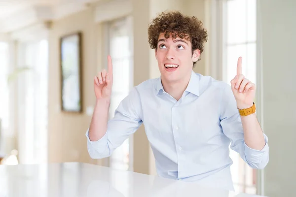 Young Business Man Curly Read Head Smiling Amazed Surprised Pointing — Stock Photo, Image