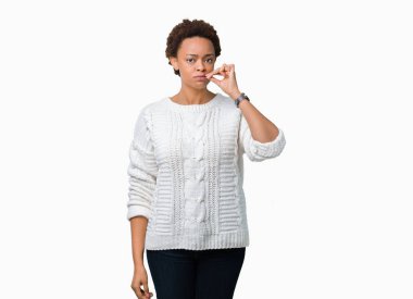 Beautiful young african american woman wearing sweater over isolated background mouth and lips shut as zip with fingers. Secret and silent, taboo talking clipart