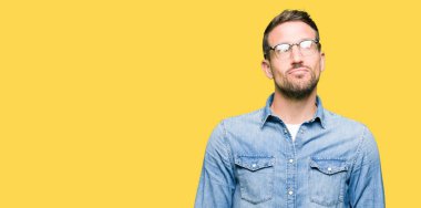 Yakışıklı adam gözlük takan yan bakıyor gülümseyerek ve düşünme uzak bakıyor.