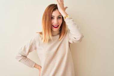 Kırmızı saçlı kadın izole beyaz arka plan üzerinde duran zarif boğazlı kazak giyen kamera emin görünümlü çapraz kollar ve el çene üzerinde kaldırdı gülümseyerek. Olumlu düşünme.