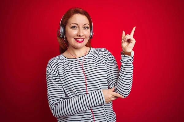 Junge Rothaarige Frau Die Musik Über Kopfhörer Über Rotem Isoliertem — Stockfoto