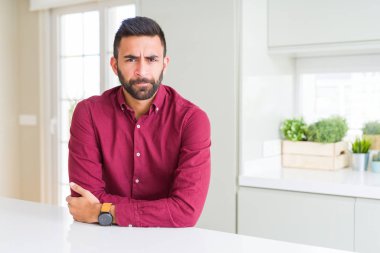 Yakışıklı İspanyol iş adamı şüpheci ve sinir, onaylamayan ifade yüz çapraz kolları üzerinde. Negatif kişi.