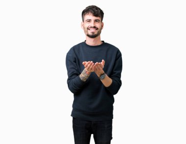 Yakışıklı delikanlı izole arka plan üzerinde gülen ellerle birlikte alma veya jest vererek palms. Ayrı tutma ve koruma