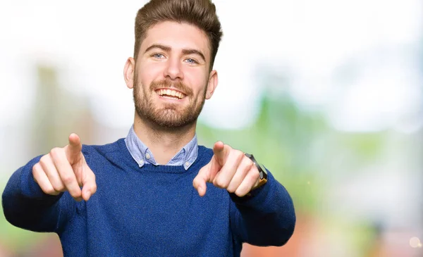 Young handsome bussines man Pointing to you and the camera with fingers, smiling positive and cheerful
