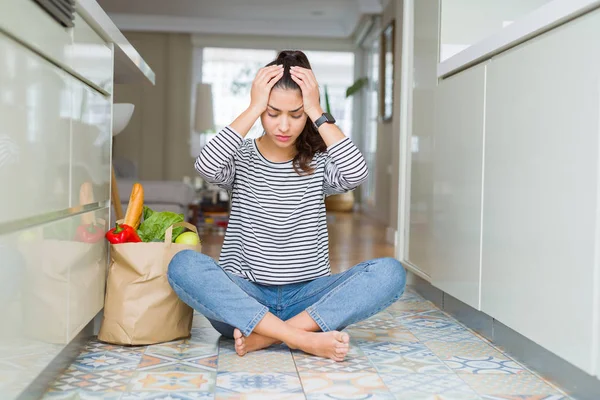 Young Woman Sitting Kitchen Floor Paper Bag Full Fresh Groceries — Stock Photo, Image