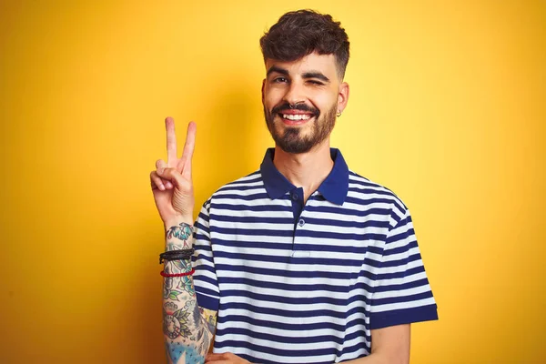 Young Man Tattoo Wearing Striped Polo Standing Isolated Yellow Background — Stock Photo, Image