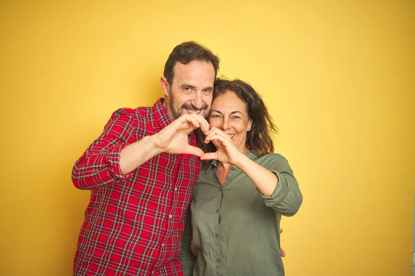 Beautiful Middle Age Couple Isolated Yellow Background Smiling Love Doing — Stock Photo, Image