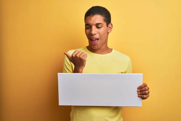 Young Handsome Arab Man Holding Banner Standing Isolated Yellow Background — Stock Photo, Image