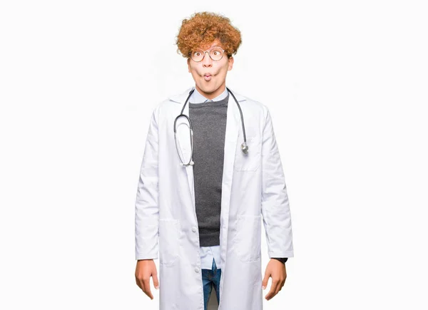 Young Handsome Doctor Man Wearing Medical Coat Making Fish Face — Stock Photo, Image