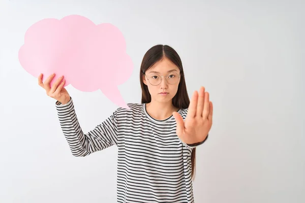 年轻的中国妇女拿着云语音泡沫在孤立的白色背景与张开的手做停止标志与认真和自信的表情 防御姿态 — 图库照片