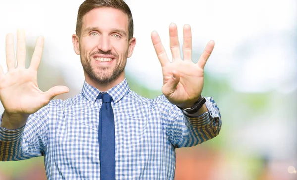 Handsome business man wearing tie showing and pointing up with fingers number nine while smiling confident and happy.