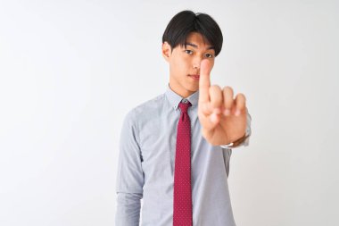 Izole beyaz arka plan üzerinde duran zarif kravat giyen Çinli işadamı parmak yukarı ve kızgın ifade ile işaret, hiçbir jest gösteren