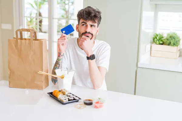 Joven Comiendo Sushi Asiático Entrega Domicilio Usando Tarjeta Crédito Como — Foto de Stock